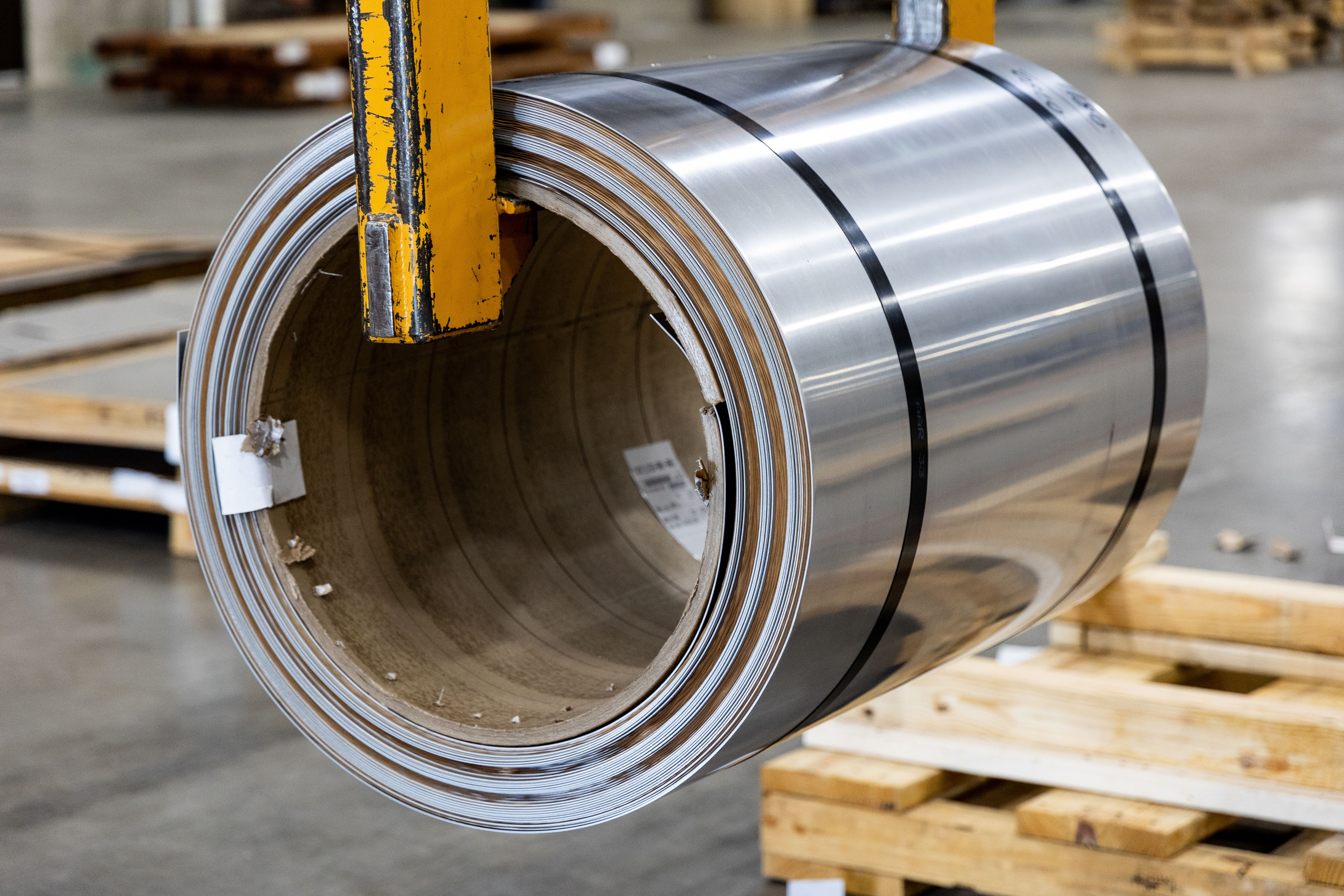 Steel sheet coil being lifted in a plant