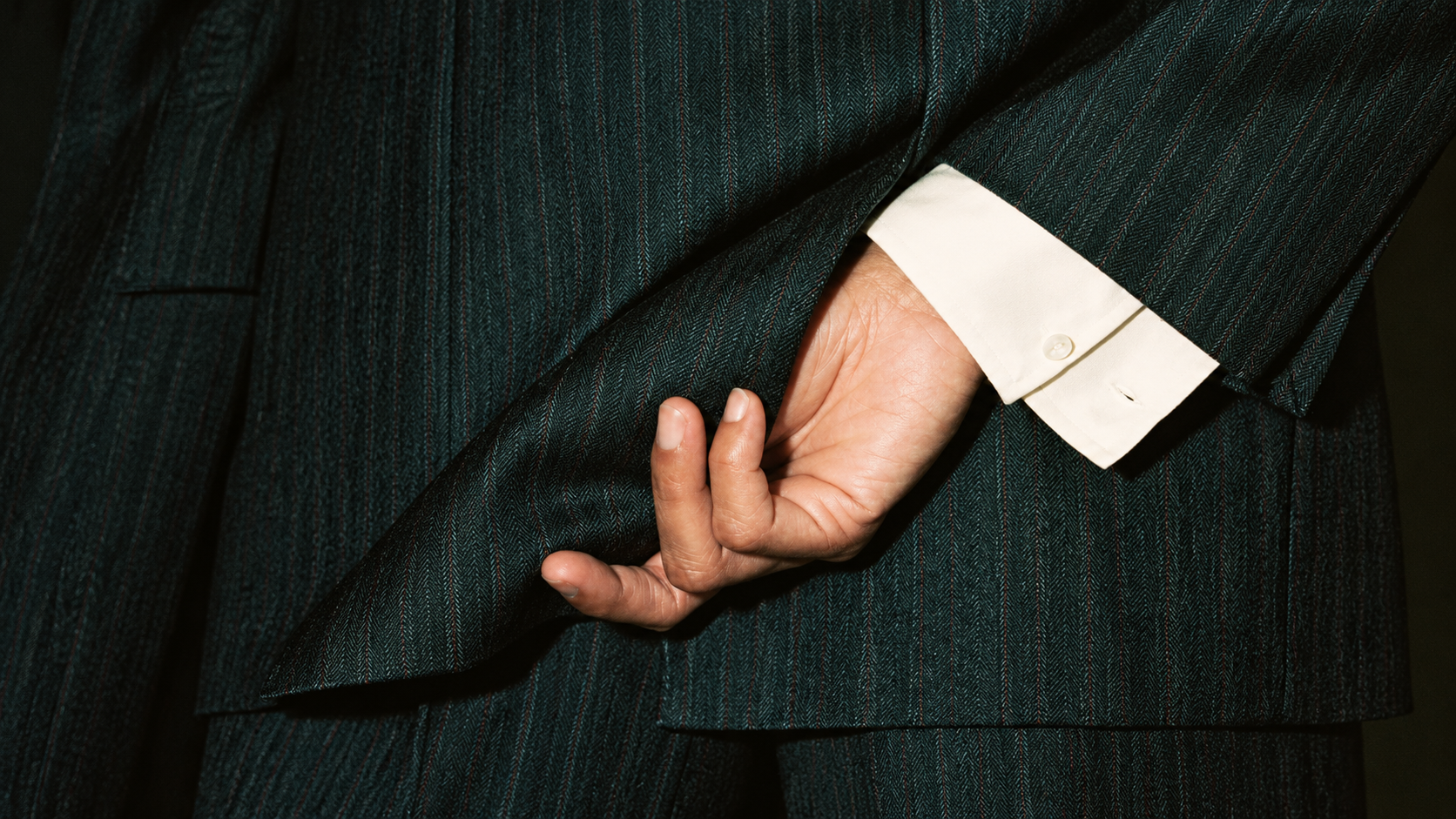 Close-up of a pinstripe suit and shirt cuff